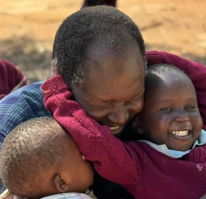 Joseph embracing one of the children