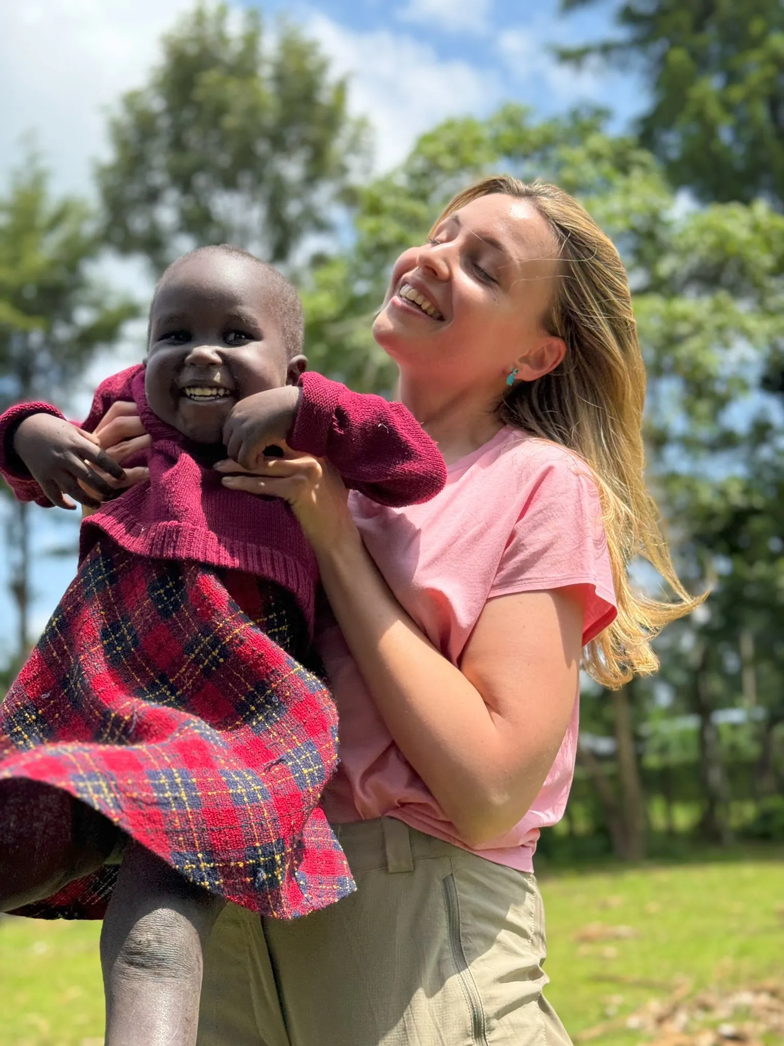 A volunteer holding one of the children